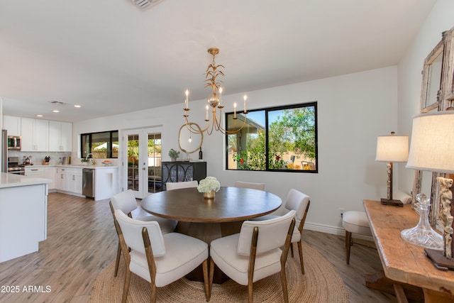 dining area with baseboards, recessed lighting, a wealth of natural light, and light wood-style floors