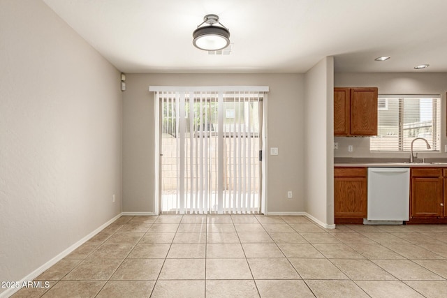 125 N 22nd Pl Unit 53, Mesa, AZ 85213 - kitchen with white dishwasher, a sink, brown cabinets, light countertops, and light tile patterned floors