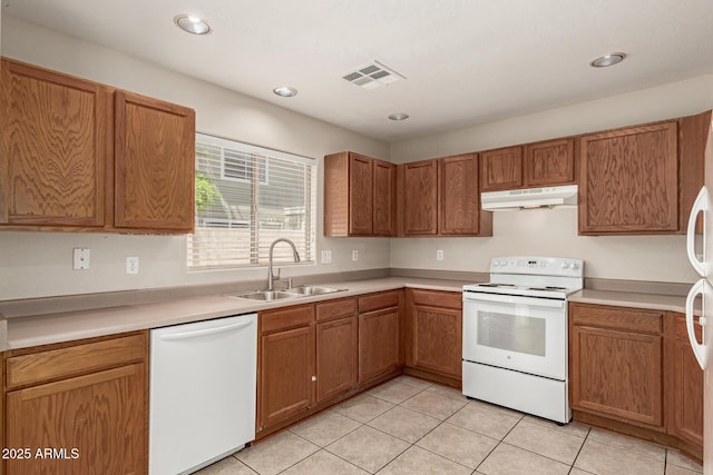 125 N 22nd Pl Unit 53, Mesa, AZ 85213 - kitchen with white appliances, under cabinet range hood, a sink, light tile patterned flooring, and light countertops