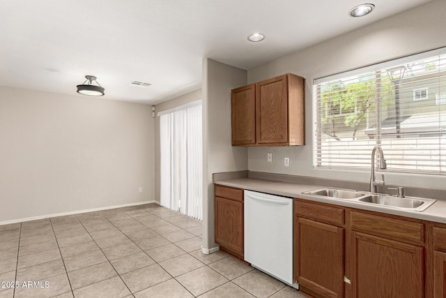 125 N 22nd Pl Unit 53, Mesa, AZ 85213 - kitchen with white dishwasher, a sink, light tile patterned flooring, light countertops, and brown cabinetry
