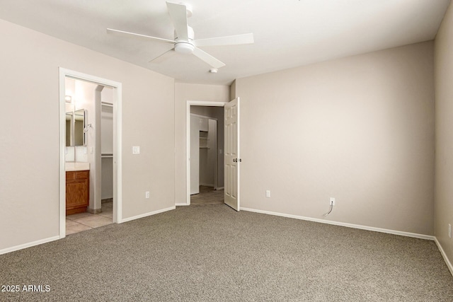 125 N 22nd Pl Unit 53, Mesa, AZ 85213 - unfurnished bedroom featuring light colored carpet, baseboards, ensuite bath, ceiling fan, and a spacious closet
