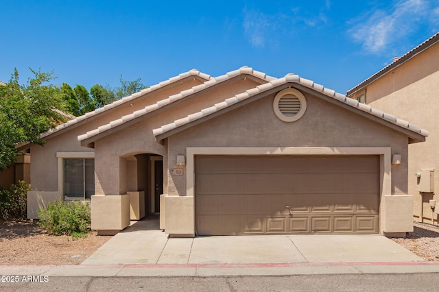 125 N 22nd Pl Unit 53, Mesa, AZ 85213 - view of front of property featuring stucco siding, an attached garage, a tile roof, and concrete driveway