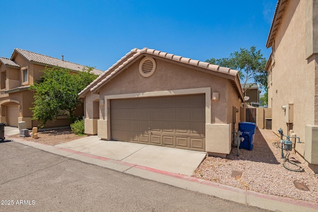 125 N 22nd Pl Unit 53, Mesa, AZ 85213 - view of front facade with stucco siding, a detached garage, and a tiled roof
