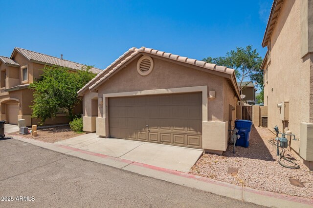 125 N 22nd Pl Unit 53, Mesa, AZ 85213 - view of front facade featuring stucco siding, a detached garage, and a tile roof