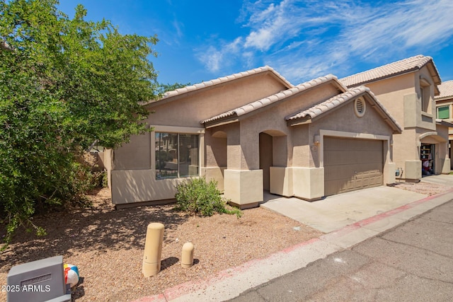 125 N 22nd Pl Unit 53, Mesa, AZ 85213 - view of front of property featuring an attached garage, concrete driveway, stucco siding, and a tiled roof
