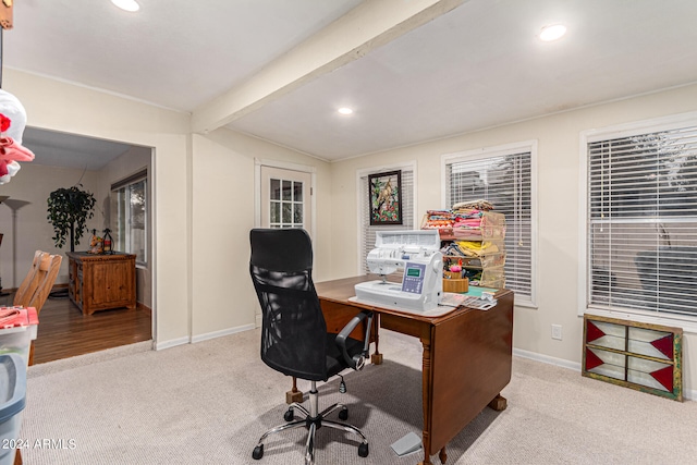 office area featuring light carpet and vaulted ceiling with beams