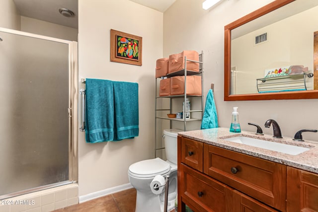 bathroom with vanity, toilet, tile patterned floors, and an enclosed shower