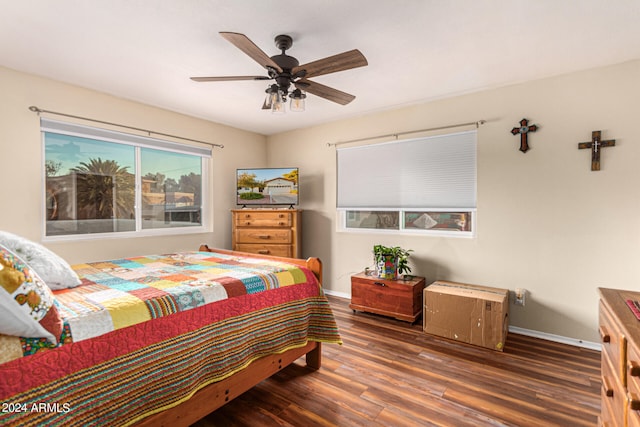 bedroom with ceiling fan and dark wood-type flooring