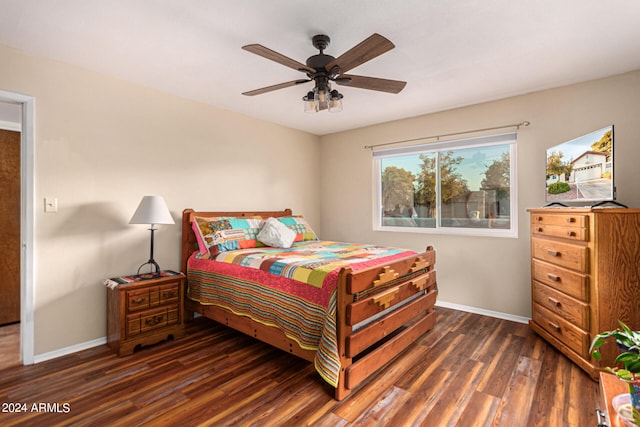 bedroom with ceiling fan and dark wood-type flooring