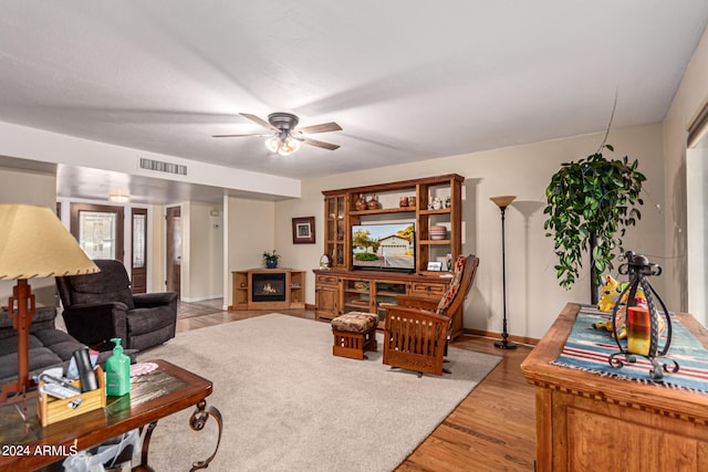 living room with light hardwood / wood-style floors and ceiling fan