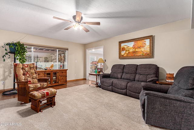 living room with ceiling fan, hardwood / wood-style flooring, plenty of natural light, and a textured ceiling