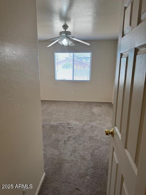 5122 E Shadow Ln, San Tan Valley, AZ 85140 - unfurnished room featuring carpet floors, a ceiling fan, a textured ceiling, and baseboards