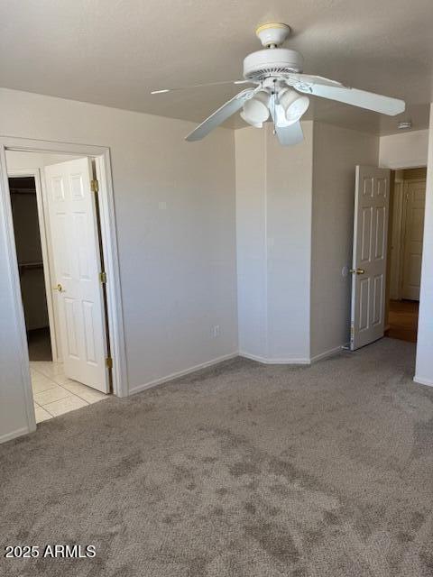 5122 E Shadow Ln, San Tan Valley, AZ 85140 - carpeted spare room featuring ceiling fan, baseboards, and tile patterned floors