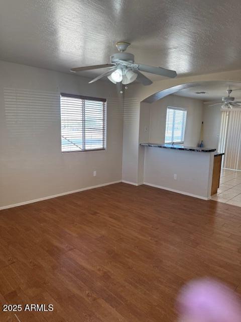 5122 E Shadow Ln, San Tan Valley, AZ 85140 - spare room with a ceiling fan, light wood-type flooring, baseboards, and arched walkways