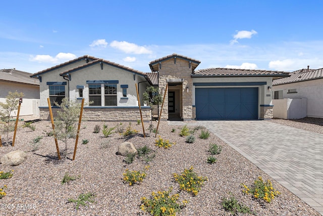 12332 W Parkway Ln, Avondale, AZ 85323 - mediterranean / spanish-style home with stone siding, a garage, stucco siding, and driveway