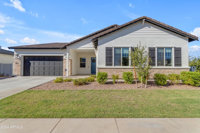 ranch-style house with a front lawn and a garage