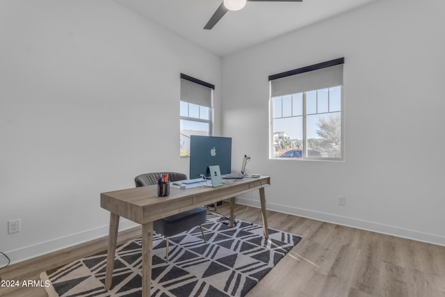 home office with ceiling fan and light hardwood / wood-style flooring