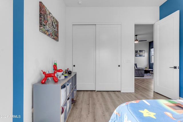 bedroom with a closet and light hardwood / wood-style floors