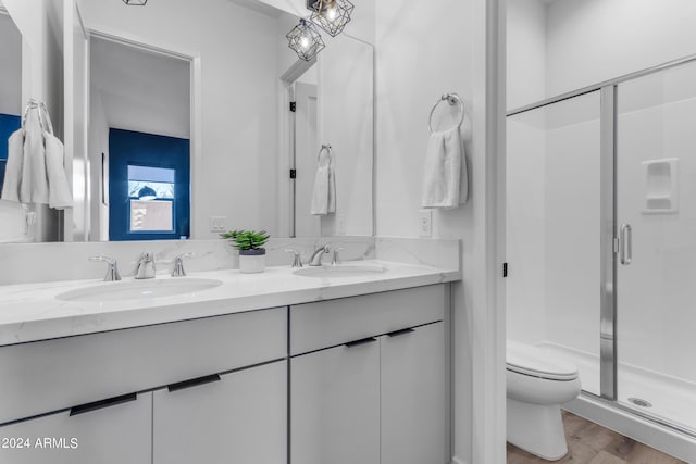 bathroom with walk in shower, vanity, toilet, and hardwood / wood-style flooring