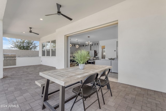 dining room featuring ceiling fan with notable chandelier