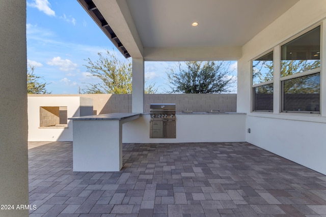 view of patio with area for grilling and exterior kitchen