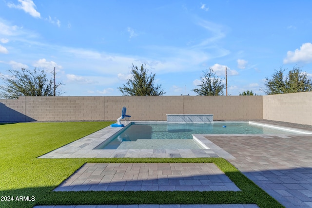 view of pool with a yard, a patio, and pool water feature