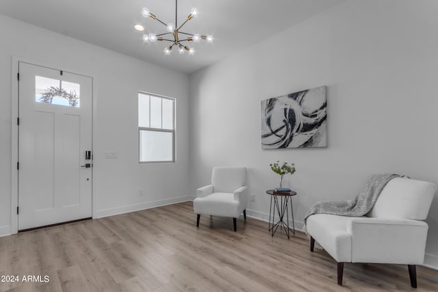 foyer entrance featuring an inviting chandelier and light hardwood / wood-style flooring