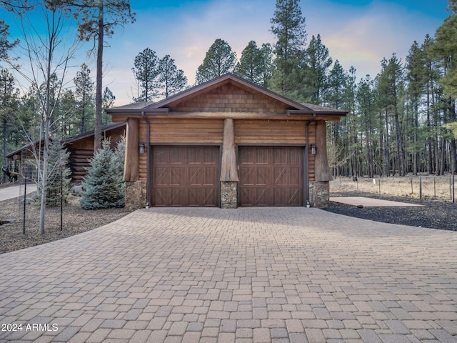 view of garage at dusk