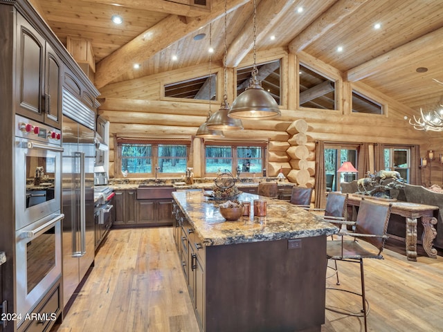 kitchen featuring light stone counters, light wood-type flooring, rustic walls, and wooden ceiling