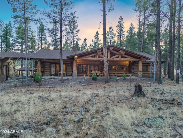 view of back house at dusk