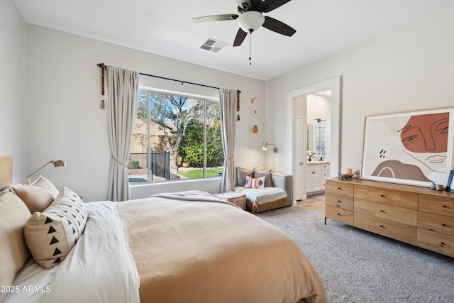 carpeted bedroom with connected bathroom and ceiling fan