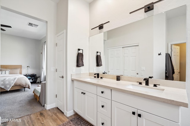 bathroom featuring vanity, hardwood / wood-style floors, and ceiling fan