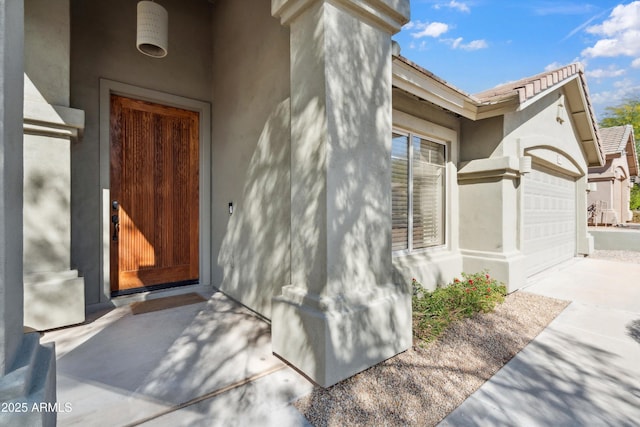 view of exterior entry featuring a garage