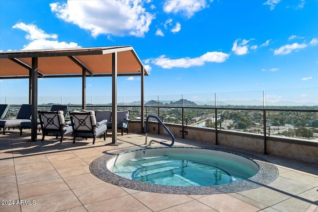 view of swimming pool with a mountain view and an in ground hot tub