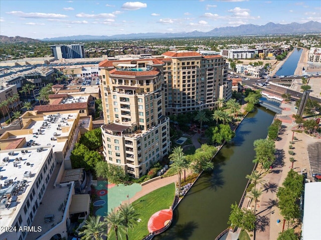 drone / aerial view featuring a water and mountain view