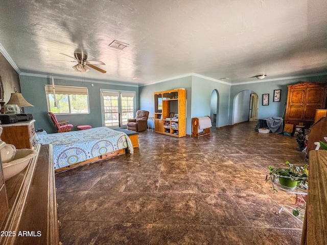 bedroom featuring arched walkways, crown molding, and a ceiling fan