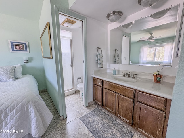 full bath featuring a ceiling fan, vanity, toilet, tile patterned floors, and a shower stall
