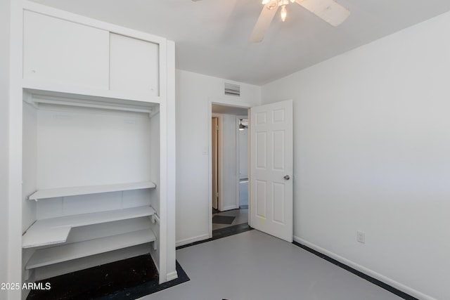 6040 N 31st Dr, Phoenix, AZ 85017 - unfurnished bedroom with finished concrete floors and a ceiling fan