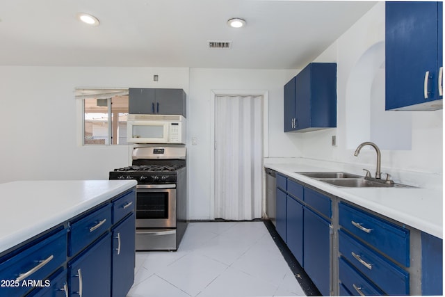 6040 N 31st Dr, Phoenix, AZ 85017 - kitchen featuring stainless steel appliances, blue cabinetry, light countertops, light tile patterned flooring, and recessed lighting