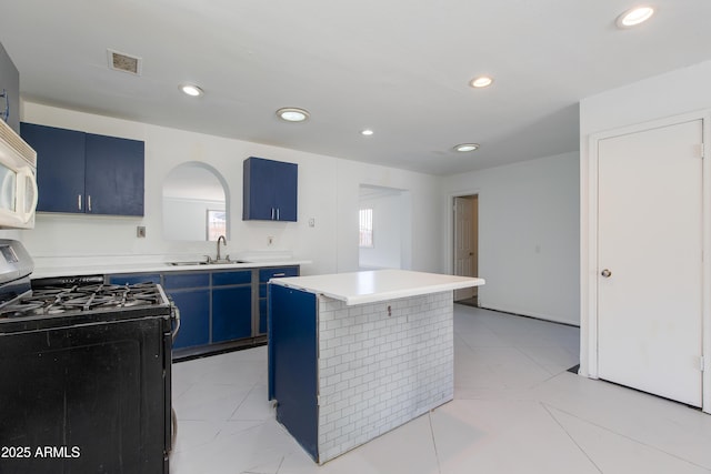 6040 N 31st Dr, Phoenix, AZ 85017 - kitchen with black gas range, blue cabinets, a center island, light countertops, and recessed lighting