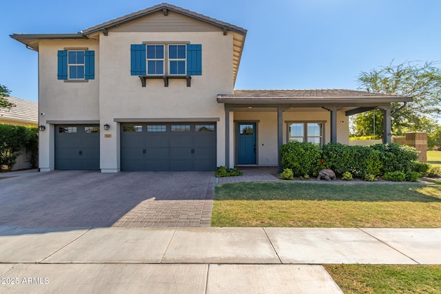 view of front of house with a garage and a front lawn