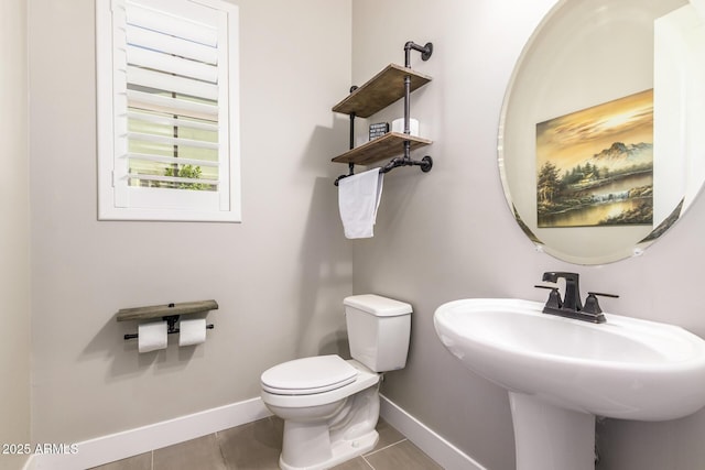 bathroom featuring tile patterned floors, toilet, and sink