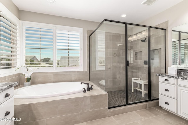 bathroom with tile patterned floors, vanity, and independent shower and bath