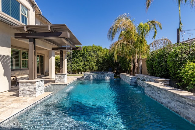 view of pool featuring an in ground hot tub, pool water feature, and a patio