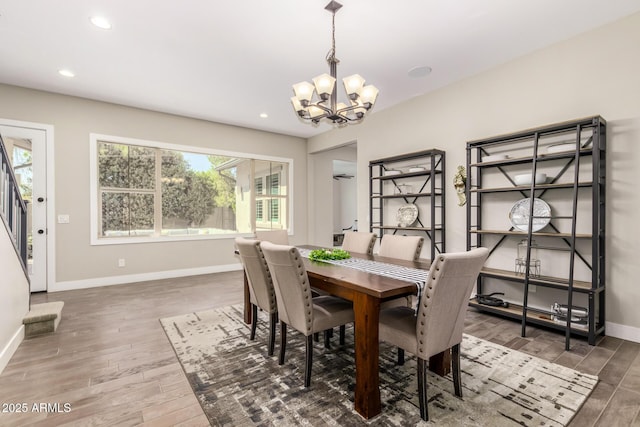 dining area featuring dark wood-type flooring and a chandelier