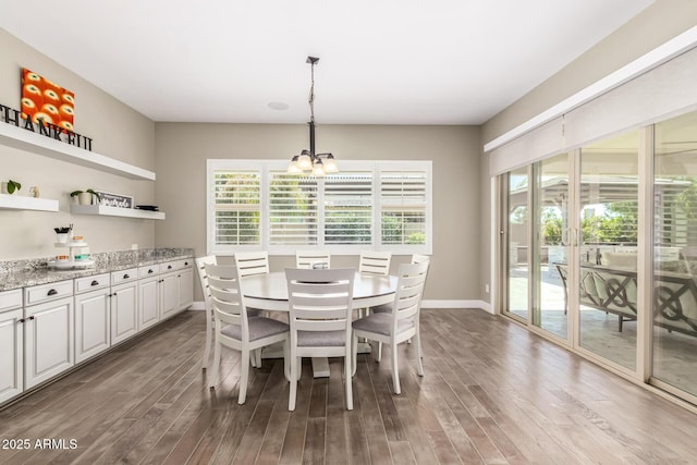 dining space with wood-type flooring and a chandelier