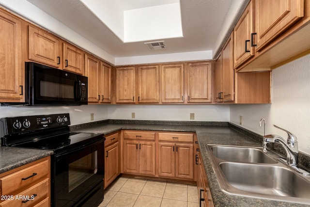 3434 E Baseline Rd Unit 216, Phoenix, AZ 85042 - kitchen with black appliances, a sink, brown cabinets, dark countertops, and light tile patterned floors