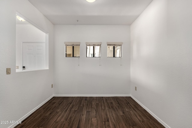 3434 E Baseline Rd Unit 216, Phoenix, AZ 85042 - spare room featuring dark wood-type flooring and baseboards