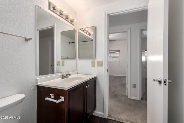 3434 E Baseline Rd Unit 216, Phoenix, AZ 85042 - bathroom with toilet, vanity, and baseboards