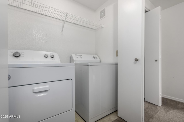 3434 E Baseline Rd Unit 216, Phoenix, AZ 85042 - laundry room featuring washer and clothes dryer, light colored carpet, and baseboards
